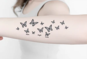 Six different butterflies streaming down arm with six kids names Aden, Aninna, Novaih, Rayla, Jayla, Teresa tattoo idea