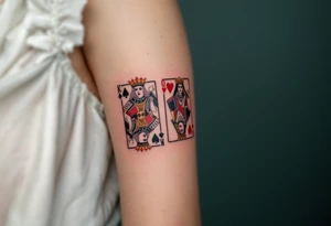 Two playing card symbols—King of Spades and Queen of Hearts—done in black, red, and subtle shading. tattoo idea