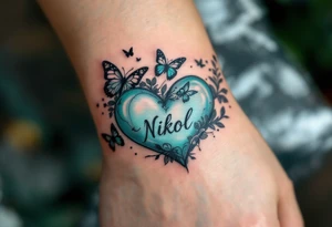 A pastel green heart with butterflies and Nikol written in elegant lowercase. tattoo idea