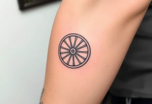 Wagon wheel with busted spokes tattoo idea