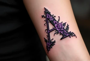 A stitched "A" design in dark purple and black, resembling embroidery. tattoo idea