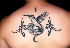 Humming bird nesting in coiled snake tattoo idea