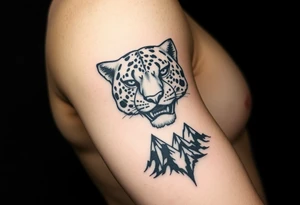 Jaguar face in the arm close to elbow mountains at the bottom close to the wrist tattoo idea