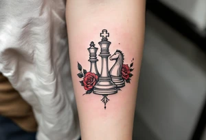 A fine-line black and gray tattoo of a chess king and queen piece intertwined with red roses. tattoo idea