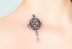 An open silver lock with swirling floral engravings, with a matching silver key hanging from a delicate chain tattoo idea