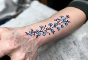 Subtle 23.03.1993 in fine black linework, wrapped in pastel blue forget-me-nots. tattoo idea