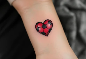 A small heart-shaped red soccer ball stitched like leather, symbolizing love for the game. tattoo idea