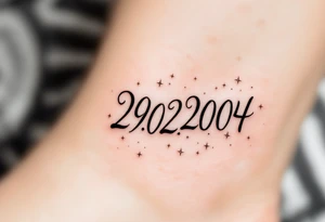 Hand-drawn date 29.02.2004 in a faded graphite tone with small stars scattered around it. tattoo idea
