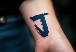 Brushstroke-style "J" in deep indigo, resembling Japanese ink calligraphy. tattoo idea