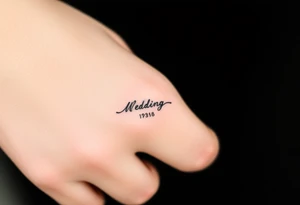 simple and elegant black wedding ring with the wedding date tattoo idea