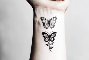 a long unique small feminine leaftattoo with two butterflies on the wrist tattoo idea