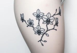 Five delicate fine line orchids different size realistic and a mix of vagina. Are connected with branches tattoo idea