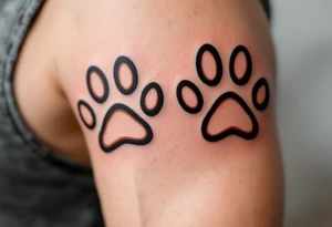 Coordinated matching paw prints in rich brown ink reflect a shared love for pets and loyalty. tattoo idea