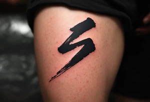A black ink brushstroke "S" inspired by Japanese calligraphy. tattoo idea