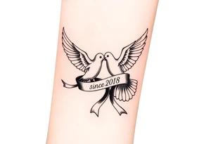 A pair of doves in mid-flight, carrying a silk ribbon with the wedding date "since" 2018. tattoo idea