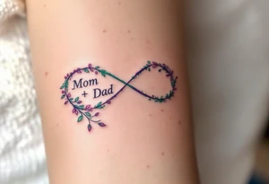 A delicate infinity symbol in violet and emerald green with “Mom + Dad” intertwined. tattoo idea