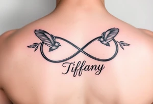 Infinity symbol with birds and the name Tiffany attached to the symbol tattoo idea
