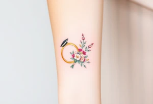 two golden wedding rings with top hat and wedding bouquet tattoo idea
