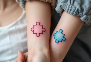 Interlocking puzzle pieces in soft pink and muted blue on the inner wrists symbolize how perfectly you fit together. tattoo idea