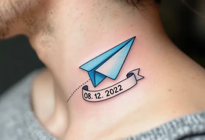 A cartoon-style paper airplane in soft grey and baby blue, trailing a banner with the birthdate 08. 12. 2022. tattoo idea