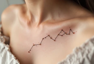 A Sagittarius constellation with stars as tiny gold dots connected by soft gray lines above the collarbone tattoo idea