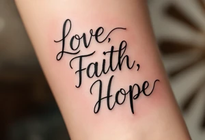 "Love, Faith, Hope" tattooed on the forearm in black serif font with thin gold underlines for emphasis. tattoo idea