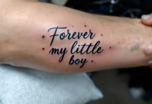 A delicate script quote like “Forever my little boy” with the O replaced by a blue planet. tattoo idea