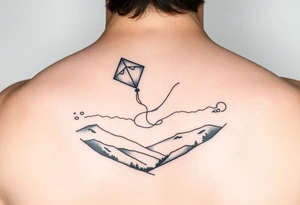 Kite in the country hand holding a kite. Over the hills tattoo idea