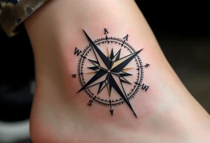 A monochrome compass with gold highlights points toward the path of freedom and adventure. tattoo idea