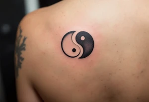 A yin-yang symbol split between two tattoos: the first half in black and white on one wrist, and the second complementary half in the same colors on the other wrist. tattoo idea