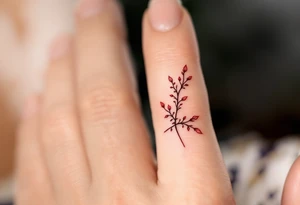 A tiny, delicate red finger band tattoo idea