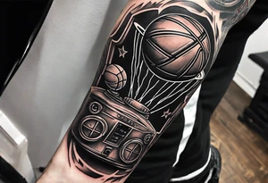 A forearm tattoo that includes a basketball hoop and a cross and a video game controller tattoo idea