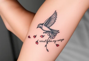 Soaring robin with trail of red rose petals with writing saying wind beneath my wings tattoo idea