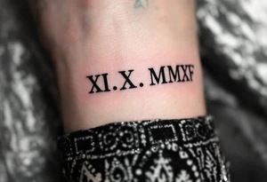 Bold black Roman numerals XII.X.MMXV etched along the collarbone, representing a wedding date in sharp serif font. tattoo idea