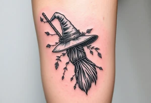 Which is broom with a witches hat with vines and feathers on your leg tattoo idea