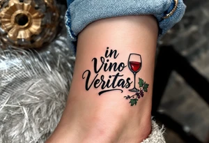 "In Vino Veritas" (In wine, there is truth), inked in a playful italic serif font, next to a realistic wine glass and grapevine, colored in deep burgundy, leaf green, and black linework. tattoo idea