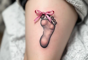 A tiny footprint in soft gray with a pink ribbon tied around it, personalized with a birthdate Lena 26. 03. 2019. tattoo idea