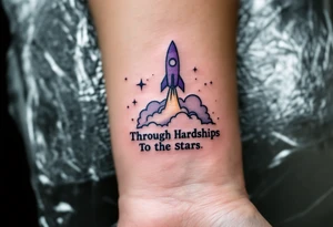 The phrase “Through Hardships To the Stars” in serif black is tattooed beneath a violet rocket ship breaking past a gray cloud. tattoo idea