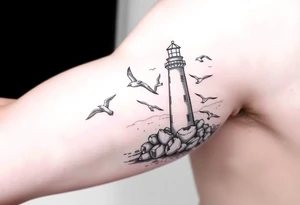 upper arm tattoo sea with lighthouse surrounded by seagulls tattoo idea