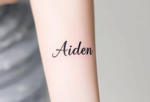 The name Aiden with shading around it tattoo idea