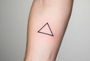 A minimalist black triangle pointing upward, symbolizing stability and strength tattoo idea