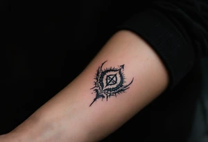 A silver-colored Makosh symbol tattoo honors fate and feminine wisdom on the forearm. tattoo idea