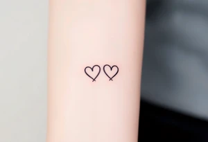 A minimalist infinity symbol with two tiny hearts at the end of each loop, rendered in a thin, black ink for a subtle, timeless look tattoo idea