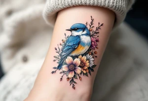 Puffy bluebird surrounded by wild flowers tattoo idea