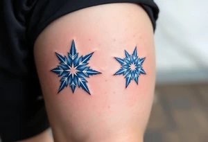 Icy blue eight-point stars with light gray accents, centered on each kneecap, resembling frost or snowflakes with a crisp, cold feeling. tattoo idea