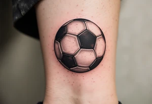 A vintage-style soccer ball shaded in sepia and brown tones with cursive lettering. tattoo idea