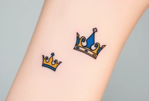 A tiny crown for the child and a regal crown for the parent, in soft gold and deep royal blue, symbolizing unconditional love and royalty tattoo idea