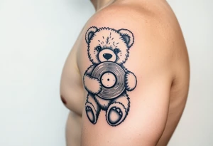 teddy bear holding a vinyl record tattoo idea