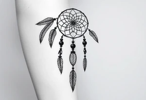 native dreamcatcher with flowing feathers and sacred beads tattoo idea