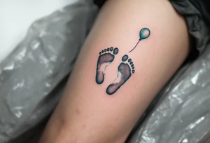 Light gray and soft teal footprints of Samuel, with a small, floating balloon to represent his light and carefree character. tattoo idea